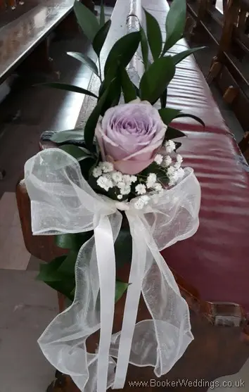 Lilac rose and gypsophila pew end at Blessed Sacrement