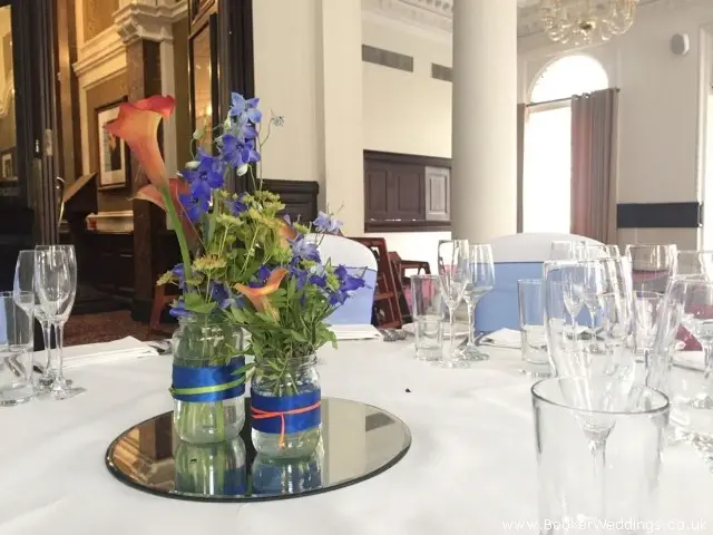Glass Jars With Flowers And Mirror Plates for Wedding Venue