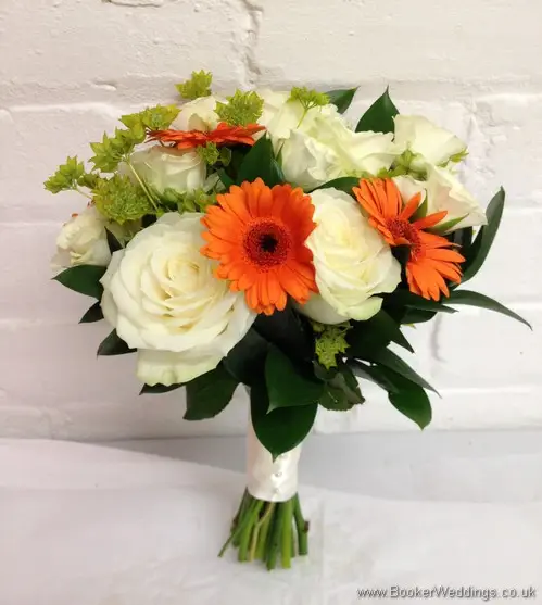 Bridal hand tied bouquet in oranges with gerberas, creams roses and spray roses Side View