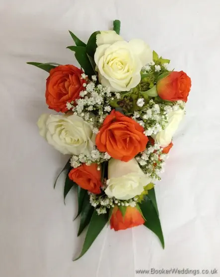 Bridal pin corsage with orange and cream spray roses with gypsy grass