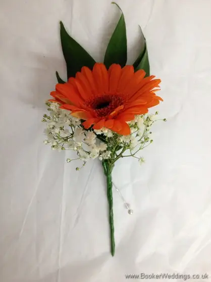 Bridesmaid buttonholes of orange gerberas with gypsy grass