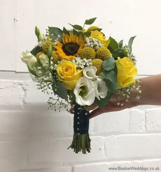 Bridal handtied bouquet in yellow and creams with yellow sunflowers, craspedia, roses, gypsy grass, lissanthus and grey eucalyptus tilted view