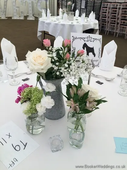 Jars of Just Picked English Country Garden style flowers as table centrepieces at the vets ball at Thornton Manor