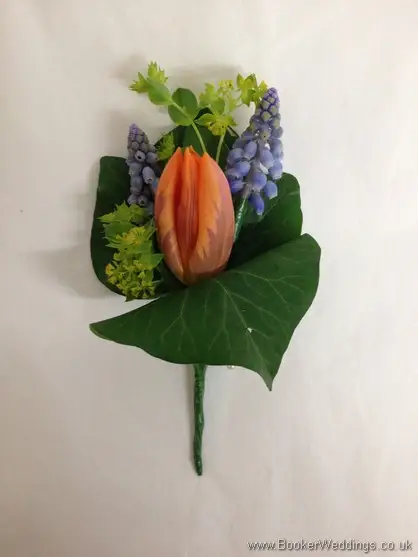 Grooms Buttonhole in a Spring Wedding Flower theme in creams, blues and oranges with muscari, tulips and bupleurum
