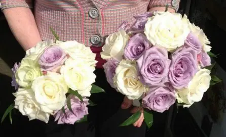 Lilac and cream rose wedding bouquets - bride and bridesmaid